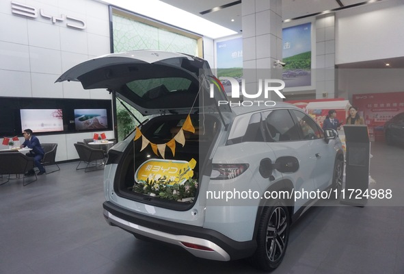 Customers buy a BYD electric car at a BYD store in Hangzhou, China, on October 31, 2024. 