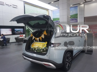 Customers buy a BYD electric car at a BYD store in Hangzhou, China, on October 31, 2024. (