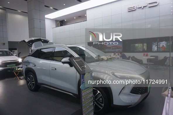 Customers buy a BYD electric car at a BYD store in Hangzhou, China, on October 31, 2024. 