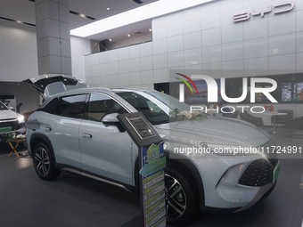 Customers buy a BYD electric car at a BYD store in Hangzhou, China, on October 31, 2024. (