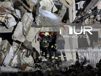 Rescuers work at a section of a nine-storey residential building destroyed by a Russian glide bomb in Kharkiv, Ukraine, on October 31, 2024....