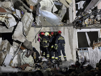 Rescuers work at a section of a nine-storey residential building destroyed by a Russian glide bomb in Kharkiv, Ukraine, on October 31, 2024....