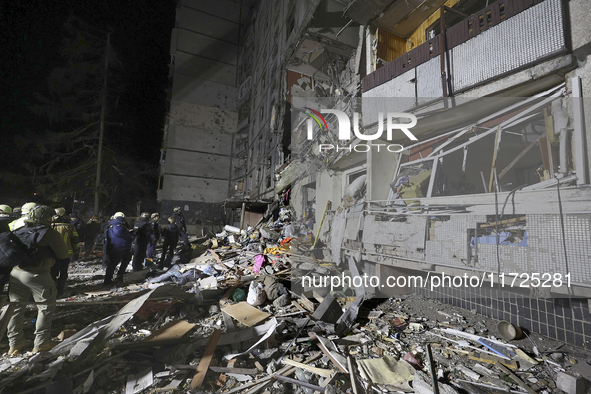 A search and rescue effort takes place outside a section of a nine-storey residential building destroyed by a Russian glide bomb in Kharkiv,...