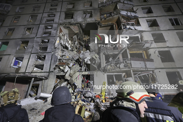 Rescuers work at a section of a nine-storey residential building destroyed by a Russian glide bomb in Kharkiv, Ukraine, on October 31, 2024....