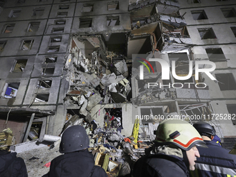 Rescuers work at a section of a nine-storey residential building destroyed by a Russian glide bomb in Kharkiv, Ukraine, on October 31, 2024....