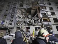 Rescuers work at a section of a nine-storey residential building destroyed by a Russian glide bomb in Kharkiv, Ukraine, on October 31, 2024....