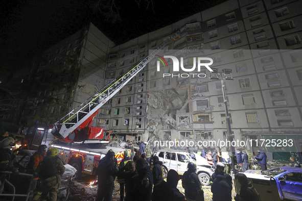 A search and rescue effort takes place outside a section of a nine-storey residential building destroyed by a Russian glide bomb in Kharkiv,...