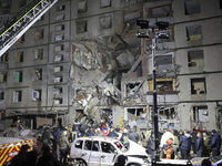 A search and rescue effort takes place outside a section of a nine-storey residential building destroyed by a Russian glide bomb in Kharkiv,...