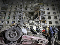 An overturned car is outside a section of a nine-storey residential building destroyed by a Russian glide bomb in Kharkiv, Ukraine, on Octob...