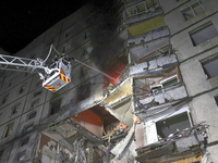 Rescuers use an aerial ladder to put out a fire in a nine-storey residential building damaged by a Russian glide bomb in Kharkiv, Ukraine, o...