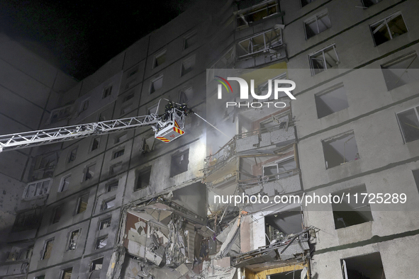 Rescuers use an aerial ladder to put out a fire in a nine-storey residential building damaged by a Russian glide bomb in Kharkiv, Ukraine, o...