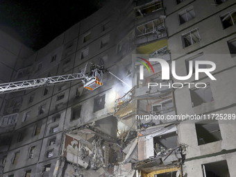 Rescuers use an aerial ladder to put out a fire in a nine-storey residential building damaged by a Russian glide bomb in Kharkiv, Ukraine, o...