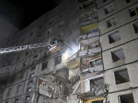 Rescuers use an aerial ladder to put out a fire in a nine-storey residential building damaged by a Russian glide bomb in Kharkiv, Ukraine, o...