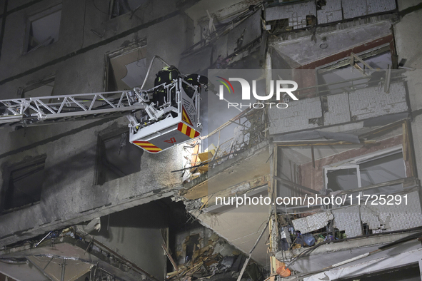 Rescuers use an aerial ladder to put out a fire in a nine-storey residential building damaged by a Russian glide bomb in Kharkiv, Ukraine, o...