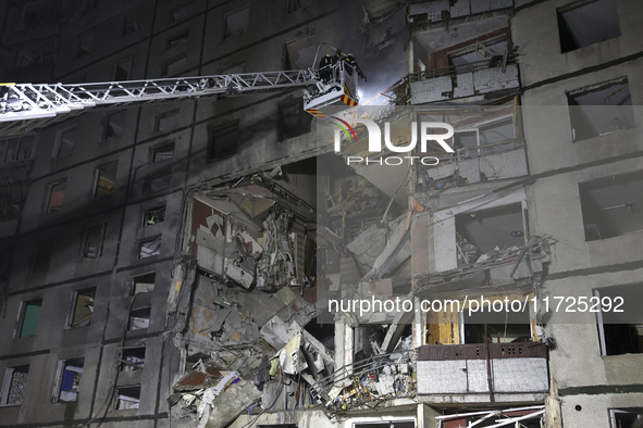 Rescuers use an aerial ladder to put out a fire in a nine-storey residential building damaged by a Russian glide bomb in Kharkiv, Ukraine, o...