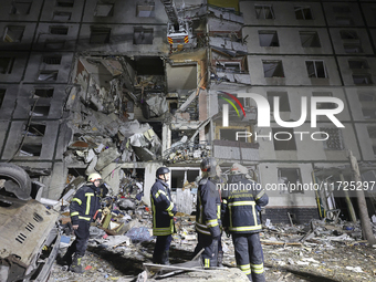 Rescuers work at a section of a nine-storey residential building destroyed by a Russian glide bomb in Kharkiv, Ukraine, on October 31, 2024....