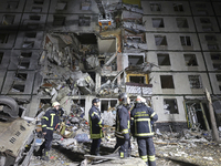 Rescuers work at a section of a nine-storey residential building destroyed by a Russian glide bomb in Kharkiv, Ukraine, on October 31, 2024....