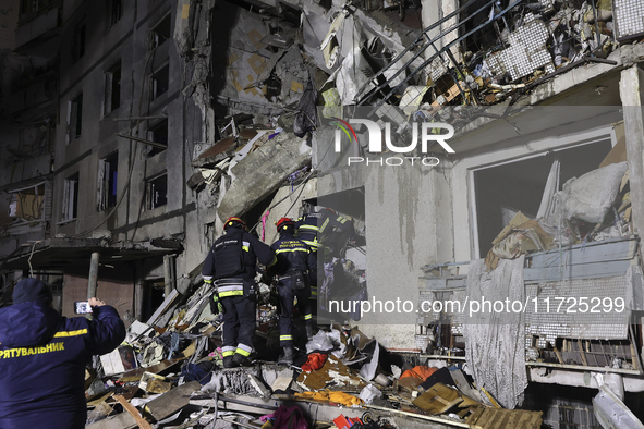 Rescuers work at a section of a nine-storey residential building destroyed by a Russian glide bomb in Kharkiv, Ukraine, on October 31, 2024....