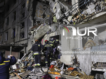 Rescuers work at a section of a nine-storey residential building destroyed by a Russian glide bomb in Kharkiv, Ukraine, on October 31, 2024....