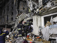 Rescuers work at a section of a nine-storey residential building destroyed by a Russian glide bomb in Kharkiv, Ukraine, on October 31, 2024....