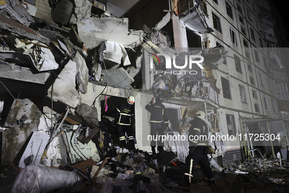 Rescuers work at a section of a nine-storey residential building destroyed by a Russian glide bomb in Kharkiv, Ukraine, on October 31, 2024....