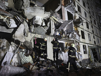 Rescuers work at a section of a nine-storey residential building destroyed by a Russian glide bomb in Kharkiv, Ukraine, on October 31, 2024....