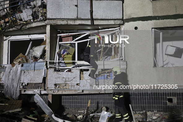 Rescuers work at a section of a nine-storey residential building destroyed by a Russian glide bomb in Kharkiv, Ukraine, on October 31, 2024....