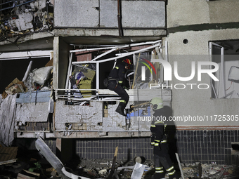 Rescuers work at a section of a nine-storey residential building destroyed by a Russian glide bomb in Kharkiv, Ukraine, on October 31, 2024....