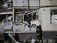 Rescuers work at a section of a nine-storey residential building destroyed by a Russian glide bomb in Kharkiv, Ukraine, on October 31, 2024....