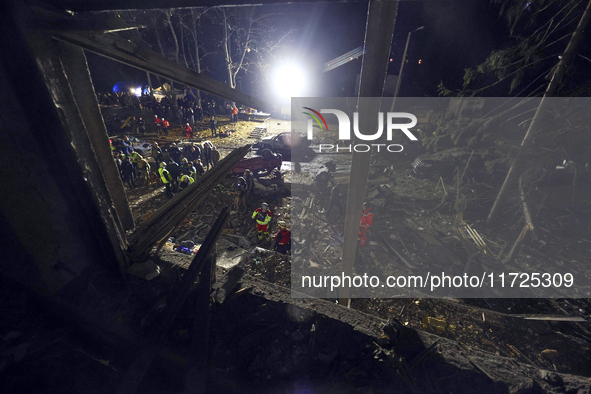 Rescuers work at a section of a nine-storey residential building destroyed by a Russian glide bomb in Kharkiv, Ukraine, on October 31, 2024....