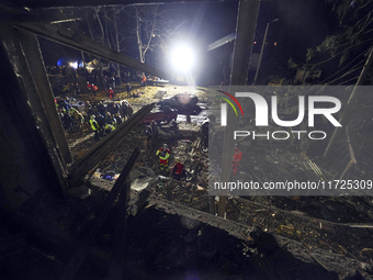 Rescuers work at a section of a nine-storey residential building destroyed by a Russian glide bomb in Kharkiv, Ukraine, on October 31, 2024....