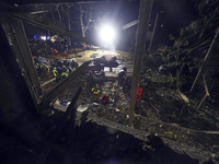 Rescuers work at a section of a nine-storey residential building destroyed by a Russian glide bomb in Kharkiv, Ukraine, on October 31, 2024....