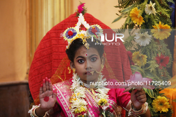 Ridhima Jana, a 9-year-old girl dressed as a Kumari, is worshiped by devotees during rituals to celebrate the Hindu festival of Kali Puja at...