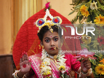 Ridhima Jana, a 9-year-old girl dressed as a Kumari, is worshiped by devotees during rituals to celebrate the Hindu festival of Kali Puja at...