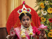 Ridhima Jana, a 9-year-old girl dressed as a Kumari, is worshiped by devotees during rituals to celebrate the Hindu festival of Kali Puja at...