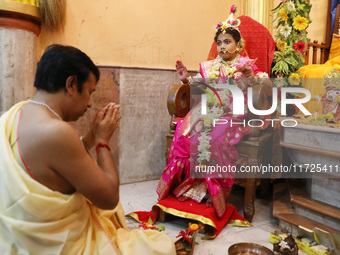 A Hindu priest offers prayer to Ridhima Jana, a 9-year-old girl dressed as a Kumari, who is worshiped by devotees during rituals to celebrat...