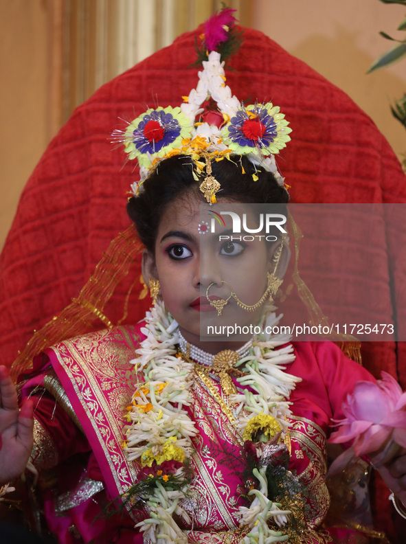 Ridhima Jana, a 9-year-old girl dressed as a Kumari, is worshiped by devotees during rituals to celebrate the Hindu festival of Kali Puja at...