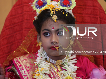 Ridhima Jana, a 9-year-old girl dressed as a Kumari, is worshiped by devotees during rituals to celebrate the Hindu festival of Kali Puja at...