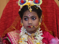 Ridhima Jana, a 9-year-old girl dressed as a Kumari, is worshiped by devotees during rituals to celebrate the Hindu festival of Kali Puja at...