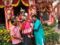 Devotees carry Ridhima Jana, a 9-year-old girl dressed as a Kumari, to give blessings after being worshipped by devotees as part of the ritu...