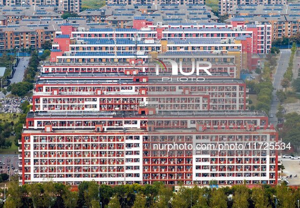 An aerial photo shows solar PV on the roof of the dormitory building of Jiangsu Agricultural and Animal Husbandry Technical College in Taizh...