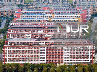 An aerial photo shows solar PV on the roof of the dormitory building of Jiangsu Agricultural and Animal Husbandry Technical College in Taizh...