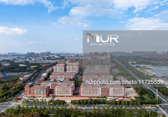 An aerial photo shows solar PV on the roof of the dormitory building of Jiangsu Agricultural and Animal Husbandry Technical College in Taizh...