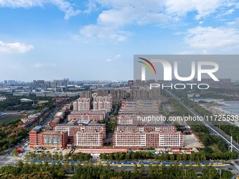 An aerial photo shows solar PV on the roof of the dormitory building of Jiangsu Agricultural and Animal Husbandry Technical College in Taizh...