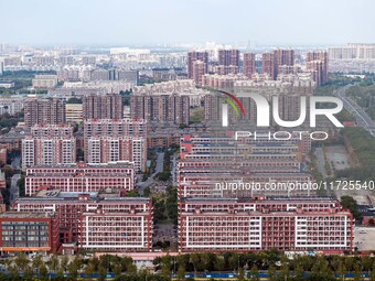 An aerial photo shows solar PV on the roof of the dormitory building of Jiangsu Agricultural and Animal Husbandry Technical College in Taizh...