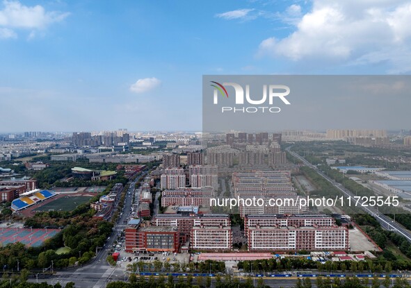 An aerial photo shows solar PV on the roof of the dormitory building of Jiangsu Agricultural and Animal Husbandry Technical College in Taizh...