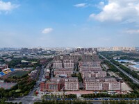 An aerial photo shows solar PV on the roof of the dormitory building of Jiangsu Agricultural and Animal Husbandry Technical College in Taizh...