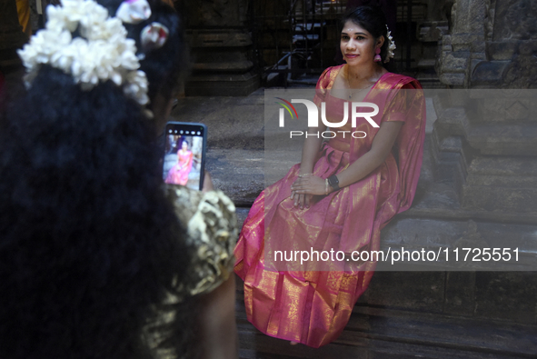 Hindu devotees take pictures in the Hindu temple in Colombo, Sri Lanka, on October 31, 2024. Deepavali, also known as Diwali, is a vibrant f...