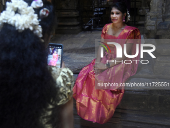 Hindu devotees take pictures in the Hindu temple in Colombo, Sri Lanka, on October 31, 2024. Deepavali, also known as Diwali, is a vibrant f...