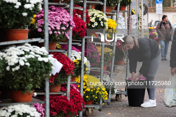 A person works at the stand with flowers near the Rakowicki Cemetery a day ahead of the All Saints Day in Krakow, Poland on October 31, 2024...